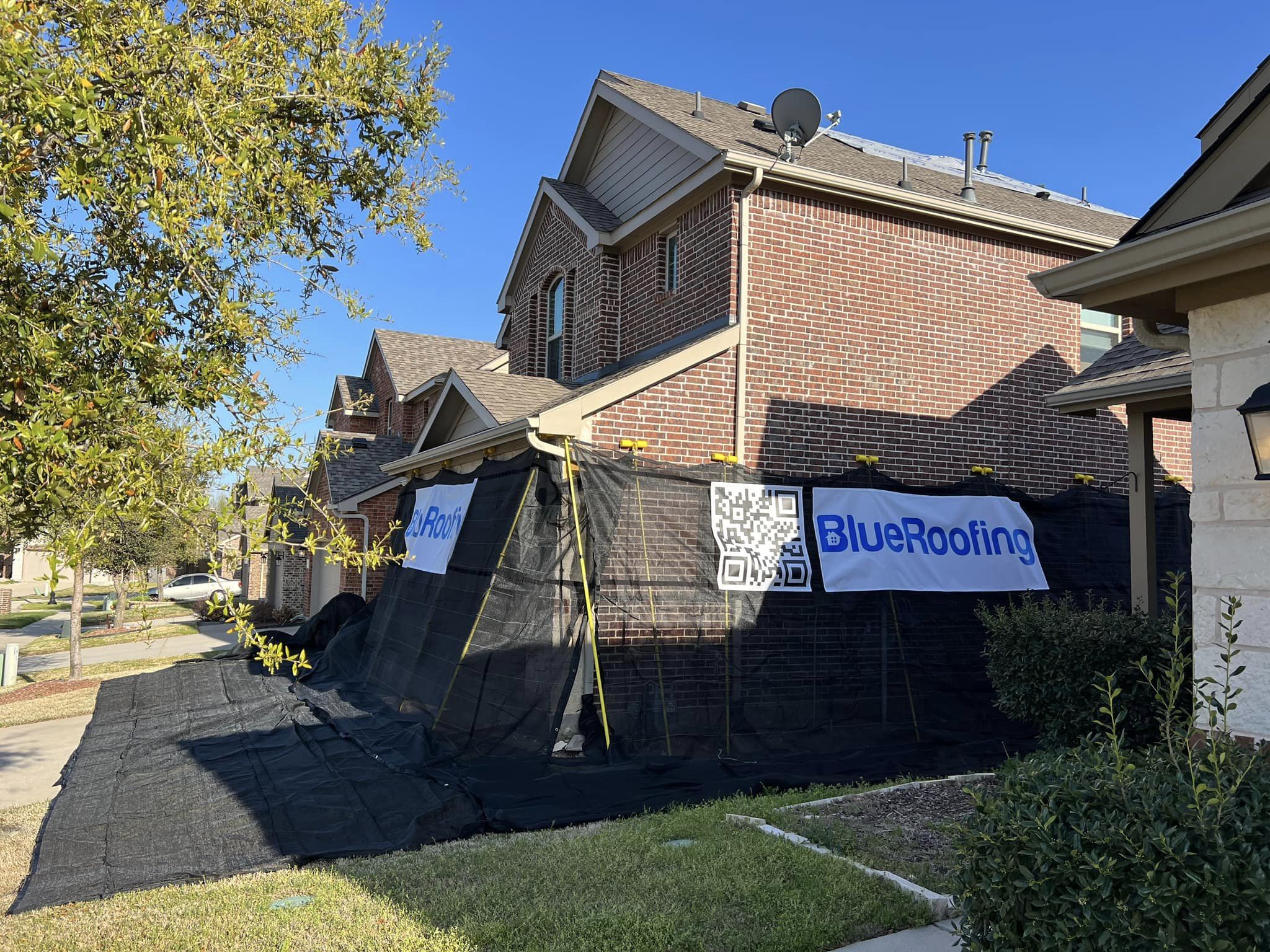 Blue Roofing crew installing a new shingle roof on a North Texas home